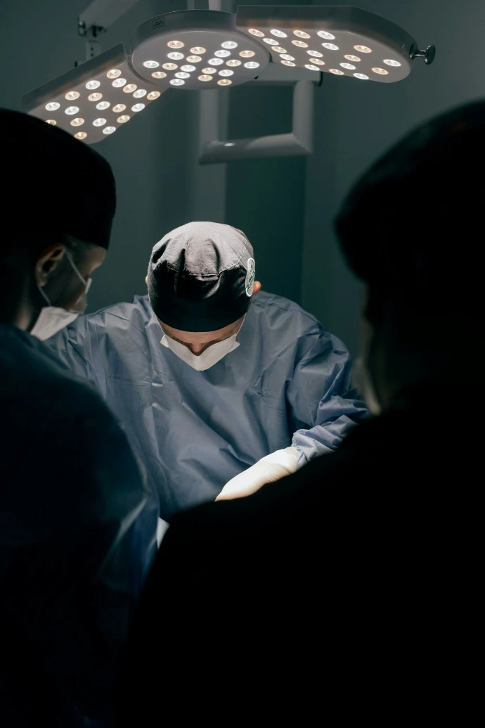 Surgeons in operating room with bright lights above
